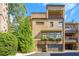 Brick townhouse showcasing private garages, balcony, and lush landscaping at 3631 Habersham Nw Rd, Atlanta, GA 30305