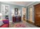 Hallway featuring hardwood floors and a decorative area rug near a plum colored sofa at 3631 Habersham Nw Rd, Atlanta, GA 30305