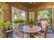 Covered patio boasts a seating area, a grill, and beautiful brick accents at 3631 Habersham Nw Rd, Atlanta, GA 30305