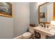 Stylish powder room features a pedestal sink, decorative mirror, and elegant fixtures at 3631 Habersham Nw Rd, Atlanta, GA 30305