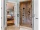 Luxurious walk-in shower with stone tile and glass doors, leading to the main bedroom at 3631 Habersham Nw Rd, Atlanta, GA 30305