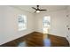 A simple bedroom with hardwood floors, white walls, and a modern ceiling fan at 960 Sharon Se Cir, Smyrna, GA 30080