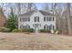 Charming two-story home with a neatly manicured front yard, white brick, and black shutters at 1782 Walker Ridge Sw Dr, Marietta, GA 30064