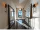 Bright hallway features a large mirror and wall sconces with natural light at 3630 Peachtree Ne Rd # 3401, Atlanta, GA 30326