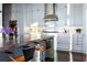 Bright kitchen with marble backsplash, stainless hood, and island with bar stool seating at 3630 Peachtree Ne Rd # 3401, Atlanta, GA 30326