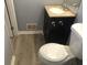 Bathroom featuring a dark vanity, toilet, and light-colored flooring in a compact space at 5250 Hollyhock Rd, Douglasville, GA 30135