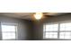 Comfortable bedroom with a ceiling fan, two large windows, and neutral walls at 5250 Hollyhock Rd, Douglasville, GA 30135