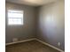 Neutral bedroom with carpeted flooring, natural light from a window, and electrical outlets at 5250 Hollyhock Rd, Douglasville, GA 30135