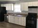 Updated kitchen with white cabinets, stainless steel dishwasher, and a black gas range stove at 5250 Hollyhock Rd, Douglasville, GA 30135