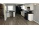 Bright kitchen featuring white cabinets, a black refrigerator and stove, plus updated flooring at 5250 Hollyhock Rd, Douglasville, GA 30135
