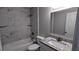 Bathroom featuring a tub-shower combo with tiled surround, and modern vanity at 3515 Weathered Wood Dr, Ellenwood, GA 30294