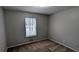 Small bedroom with neutral walls and carpet, featuring a window for natural light at 3515 Weathered Wood Dr, Ellenwood, GA 30294