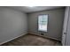 Carpeted bedroom offers a cozy space with a window providing ample natural light at 3515 Weathered Wood Dr, Ellenwood, GA 30294