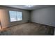 Spacious bedroom with neutral walls and carpet, featuring a large window for natural light at 3515 Weathered Wood Dr, Ellenwood, GA 30294