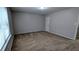 Well-lit carpeted bedroom featuring a window and neutral walls at 3515 Weathered Wood Dr, Ellenwood, GA 30294