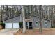 Two-story home featuring a two-car garage, gray siding, and a small, neatly landscaped front yard at 3515 Weathered Wood Dr, Ellenwood, GA 30294