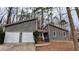 Two-story home featuring a two-car garage, gray siding, and a small, neatly landscaped front yard at 3515 Weathered Wood Dr, Ellenwood, GA 30294