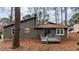 Charming home exterior with a wood deck and a wooded backyard at 3515 Weathered Wood Dr, Ellenwood, GA 30294