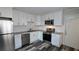 Modern kitchen features white cabinets, stainless steel appliances, granite countertops, and subway tile backsplash at 3515 Weathered Wood Dr, Ellenwood, GA 30294