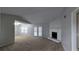 Spacious living room with high ceilings, a cozy stone fireplace, and sliding glass doors to the outside at 3515 Weathered Wood Dr, Ellenwood, GA 30294