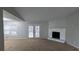 Spacious living room with high ceilings, a cozy stone fireplace, and sliding glass doors to the outside at 3515 Weathered Wood Dr, Ellenwood, GA 30294