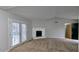 Bright living room featuring large windows, neutral carpet, and gray walls with ample space for furniture at 3515 Weathered Wood Dr, Ellenwood, GA 30294