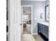 Stylish bathroom with a blue vanity, double sinks, modern fixtures, and tile flooring at 5806 Highgrove Dr, Atlanta, GA 30349