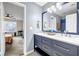 Elegant bathroom featuring double sinks, a large mirror, and blue vanity with gold hardware at 5806 Highgrove Dr, Atlanta, GA 30349