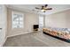 Cozy bedroom features neutral walls, carpet flooring, a ceiling fan, and bright windows at 5806 Highgrove Dr, Atlanta, GA 30349