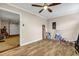 Bonus room with wood-look flooring and fan, leading into a garage space at 5806 Highgrove Dr, Atlanta, GA 30349