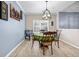 Dining room area featuring a decorative light fixture and view to the backyard through window at 5806 Highgrove Dr, Atlanta, GA 30349