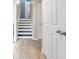 Hallway with wood-look tile flooring and white staircase at 5806 Highgrove Dr, Atlanta, GA 30349