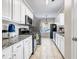 Galley kitchen featuring white cabinets, granite countertops, and stainless steel appliances at 5806 Highgrove Dr, Atlanta, GA 30349