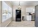Eat-in kitchen area with tile floors, stainless steel refrigerator and backyard view through window at 5806 Highgrove Dr, Atlanta, GA 30349