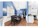 Dining area features hardwood floors, wainscoting, a modern chandelier, and seating for six at 5305 Lower Creek Ct, Cumming, GA 30040