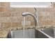 Close up of the kitchen sink with granite countertops, tile backsplash and modern style faucet at 642 Jenmarie Sw Dr, Mableton, GA 30126