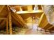 View of the unfinished attic space, featuring exposed rafters, insulation, and track lighting at 1104 Fox Ln, Woodstock, GA 30188