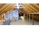 View of the unfinished attic space, featuring exposed rafters, insulation, and ventilation at 1104 Fox Ln, Woodstock, GA 30188