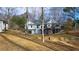 Home showcasing a spacious backyard with a large deck and wooded area at 1104 Fox Ln, Woodstock, GA 30188