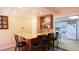 Basement bar area with granite countertop, sink, glass shelving and seating at 1104 Fox Ln, Woodstock, GA 30188