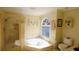 Bright bathroom with a corner jacuzzi tub, glass shower, and decorative accents at 1104 Fox Ln, Woodstock, GA 30188