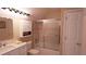 Neutral bathroom featuring a shower-tub combo with sliding glass doors and storage cabinet at 1104 Fox Ln, Woodstock, GA 30188