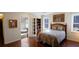 Comfortable bedroom features hardwood floors, natural light, and a view to the Primary bathroom at 1104 Fox Ln, Woodstock, GA 30188