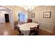 Formal dining room with hardwood floors, crown molding, and views to the foyer at 1104 Fox Ln, Woodstock, GA 30188