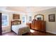 Comfortable main bedroom features hardwood floors, art, and natural light from two windows at 1104 Fox Ln, Woodstock, GA 30188