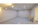 Large, well-lit rec room with recessed lighting and a new tile floor at 1104 Fox Ln, Woodstock, GA 30188