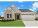 Charming single-story home featuring a combination of brick and siding, a two-car garage, and a well-manicured lawn at 1261 Burlington Ct, Mcdonough, GA 30253