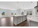 A spacious open-concept kitchen featuring stainless steel appliances, modern cabinets, and an island for cooking and entertaining at 1261 Burlington Ct, Mcdonough, GA 30253