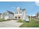 Two-story home featuring gray siding, brick accents, and a spacious driveway at 2015 Wyndham Pl, Conyers, GA 30013