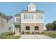 Charming two-story home with gray siding, brick facade, and inviting curb appeal on a sunny day at 2015 Wyndham Pl, Conyers, GA 30013